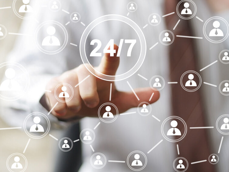 Ein Finger tippt auf ein eingeblendetes 24/7 Emblem.